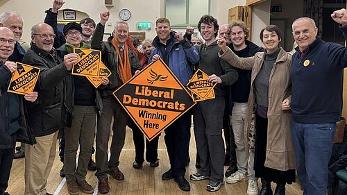 George Western celebrates with Gideon Amos MP and Lib Dem supporters