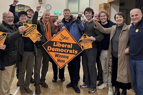 George Western celebrates with Gideon Amos MP and Lib Dem supporters