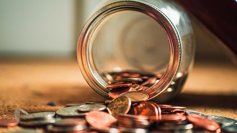 Coins coming out of a jar